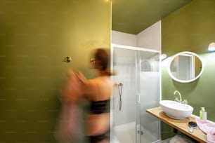 Beautiful loft interior bathroom with motion blurred woman figure in underwear