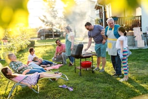 Family enjoying time they spending together in backyard. Barbecue time concept.