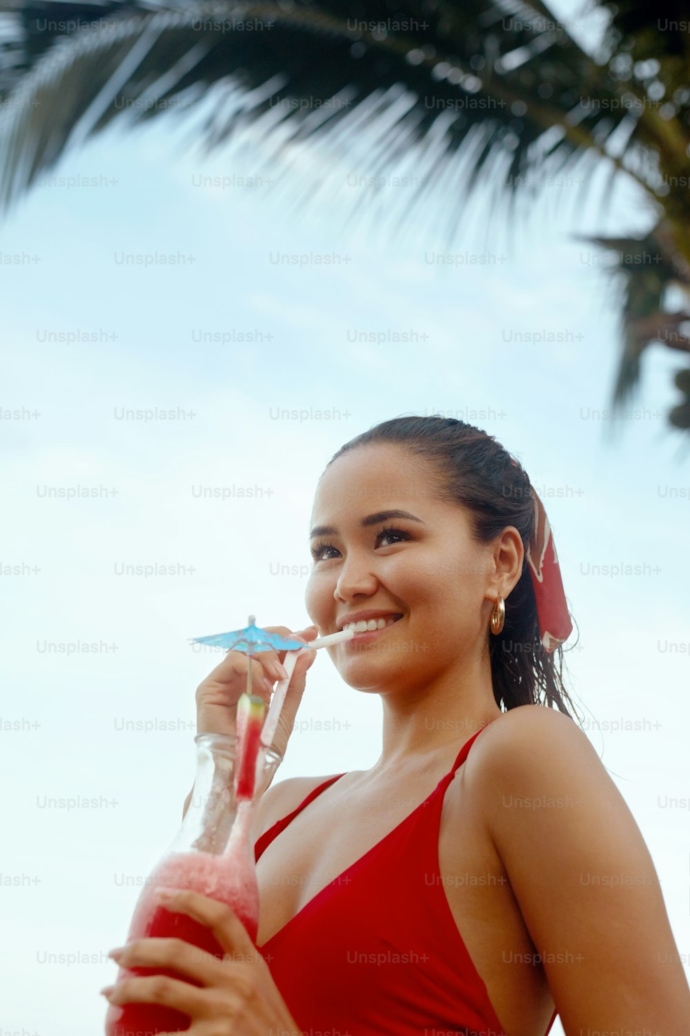 Beautiful Woman Drinking Exotic Cocktail On Beach On Summer Vacation. Asian Girl With Fruit Smoothie Drink. High Resolution