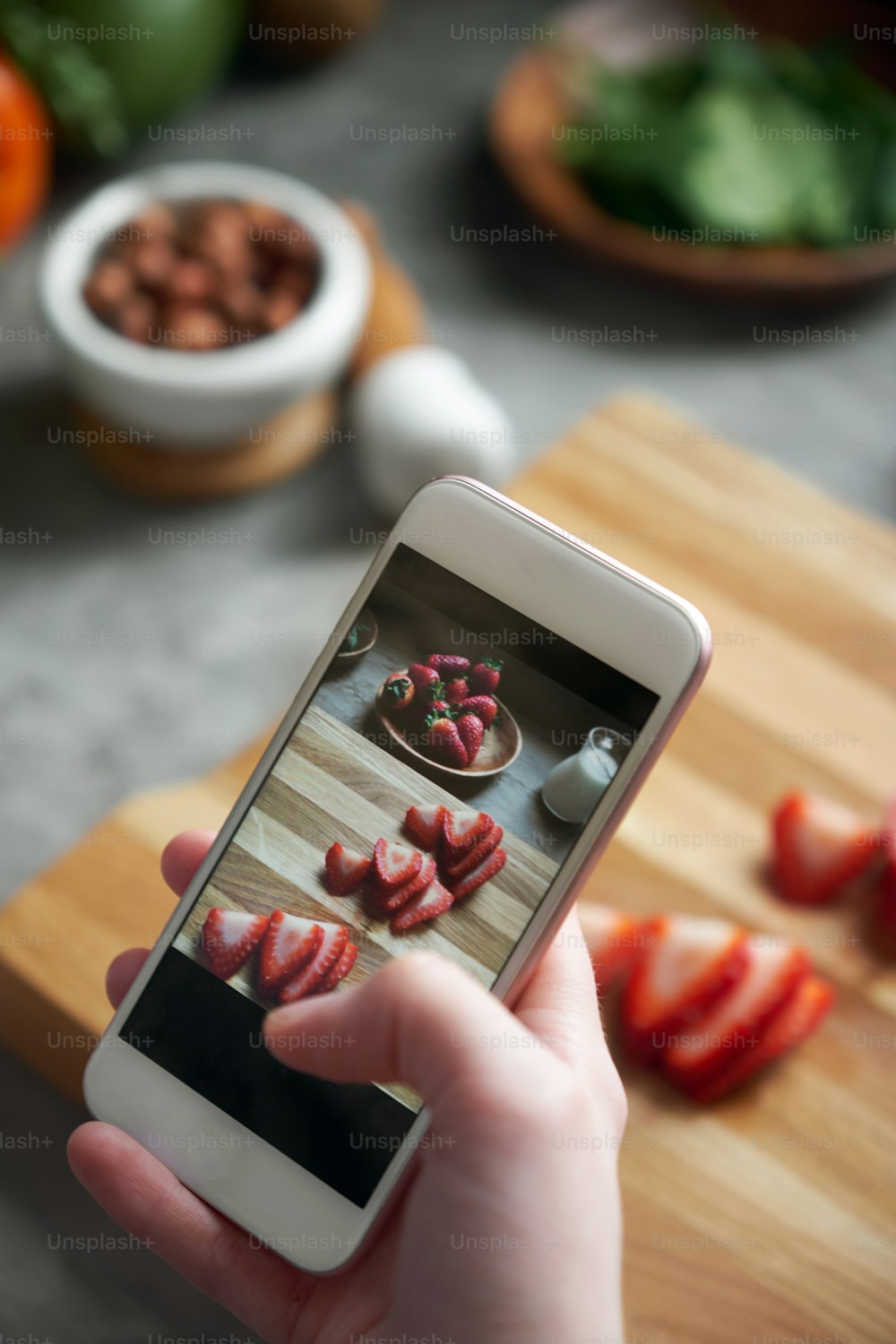 Close up view of female taking photo of healthy freshly made sandwiches with smart phone, top view