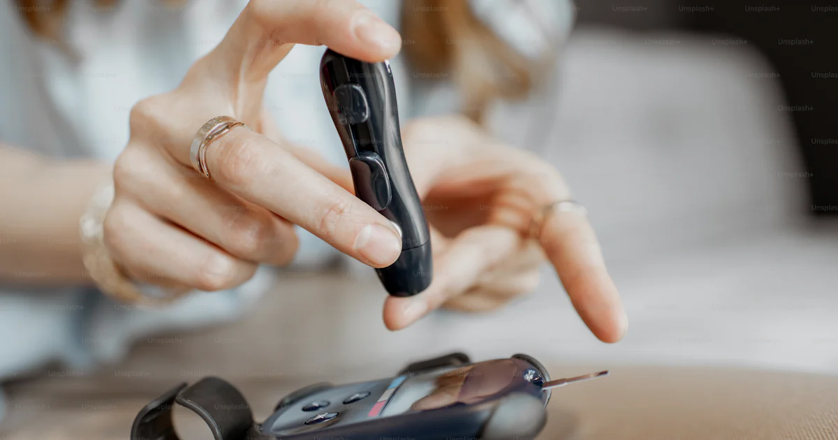 Woman Using Glucometer Young woman measuring the level of blood glucose using portable ...
