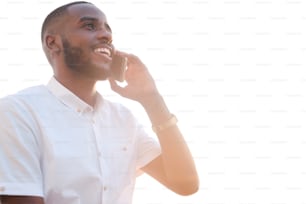 Young successful African broker or agent in white shirt holding smartphone by ear while calling clients and consulting them in front of camera