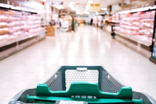 Empty cart point of view at the store market buying food and articles - defocused interior with products and meal - lockdown and quarantine or economy crisis concept