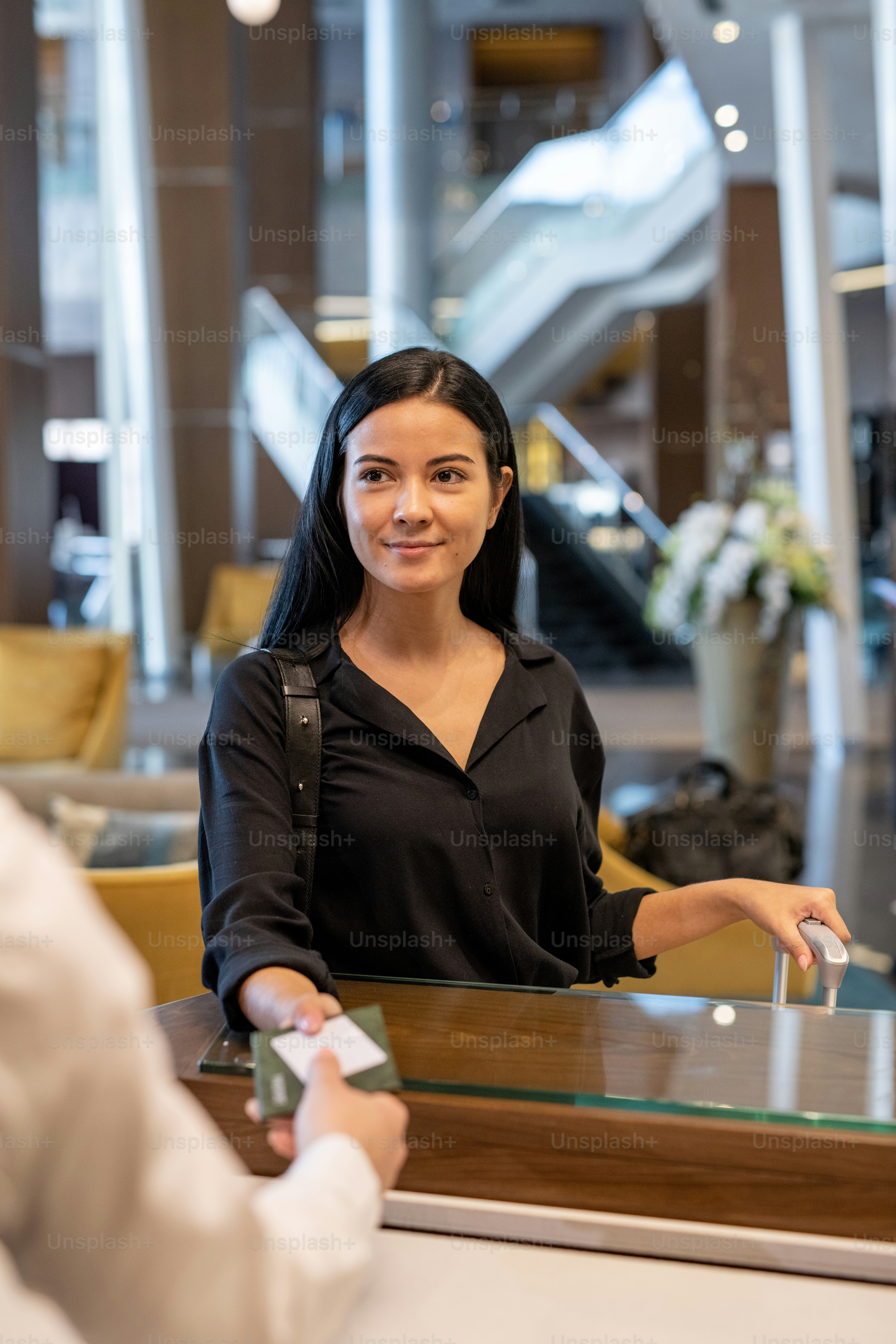 Happy young businesswoman or female traveler with luggage standing by ...