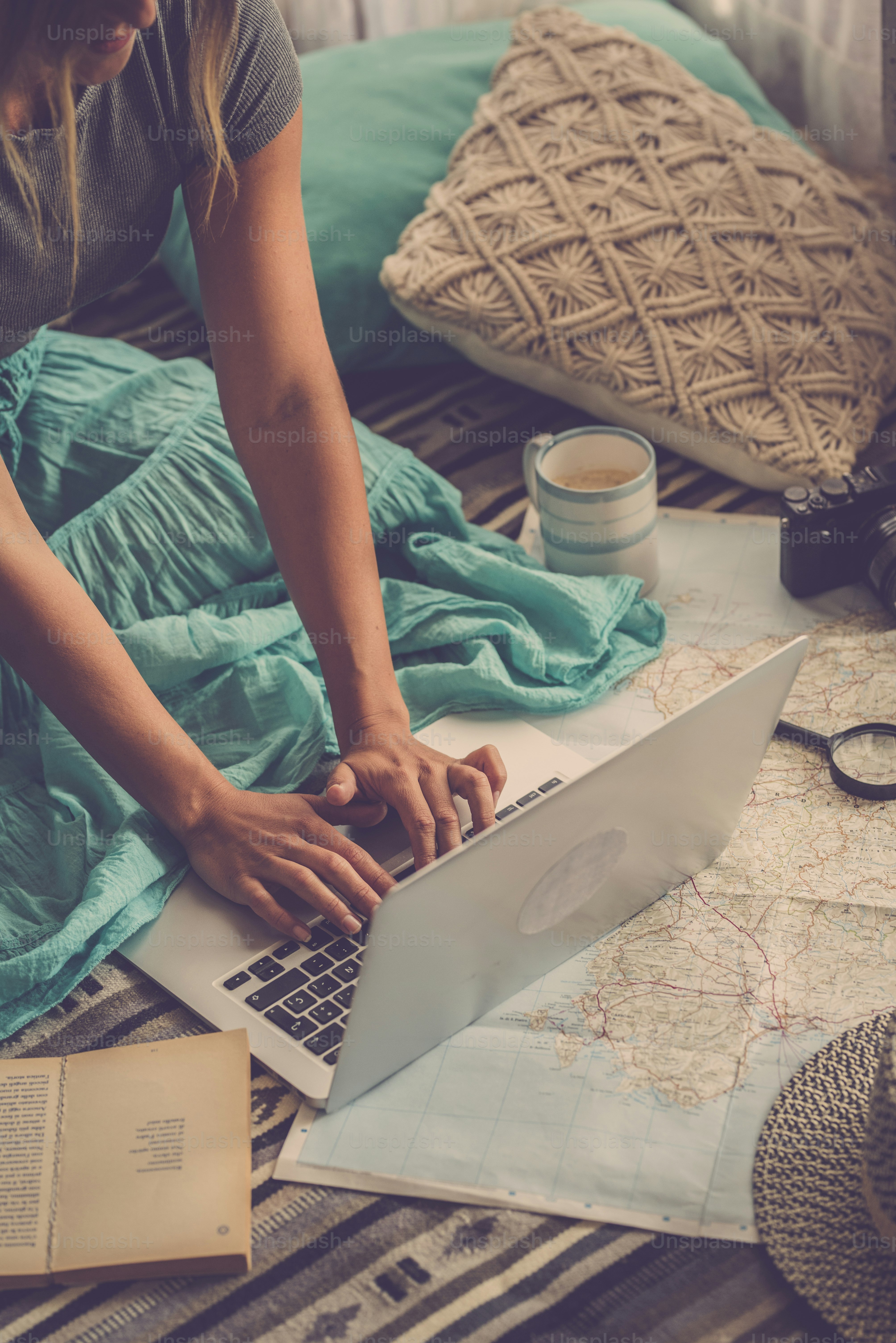 Close up of Caucasian woman planning vacation travel with laptop and internet at home, reading touristic blog online in internet while relaxing on the floor