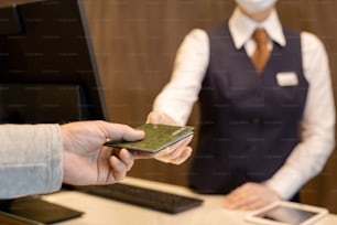 Hand of mature man taking back his passport after registration