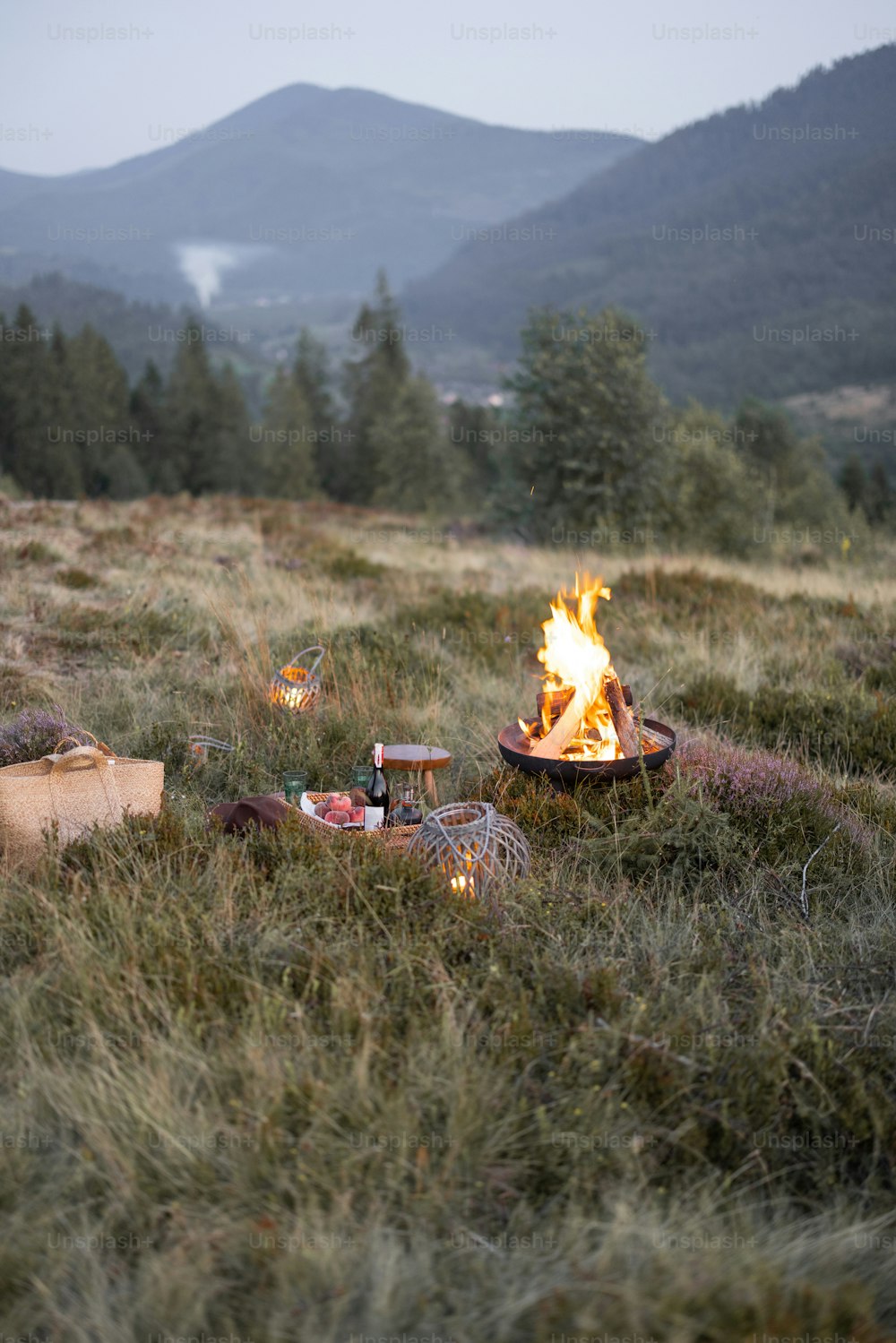 Beautiful picnic place with a campfire in the mountains on the evening