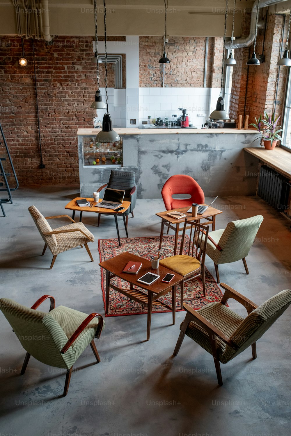 Empty office with armchairs around tables during break