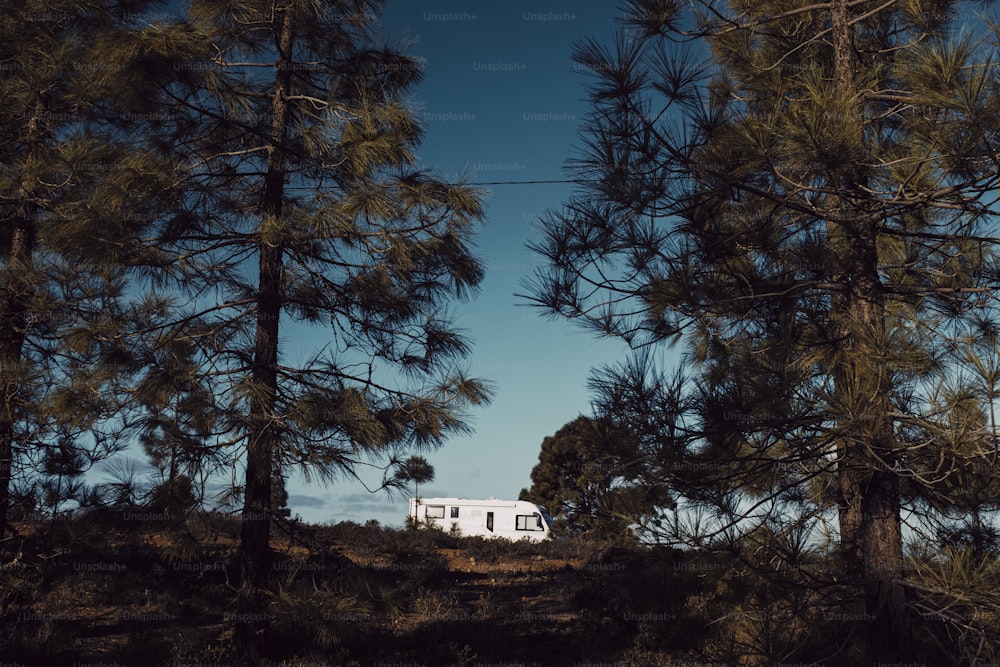 Modern camper van motorhome parked in the nature with sky view. Concept of people and travel vehicle vacation. Adventure vanlife lifestyle and nomadic life. Summer campsite holiday.