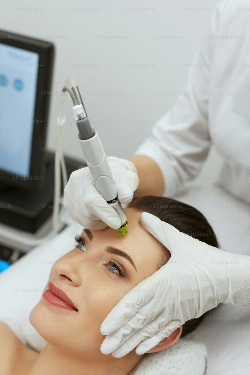 Face Skin Care. Woman Getting Facial Hydro Exfoliating Microdermabrasion Treatment At Cosmetology Beauty Clinic. High Resolution