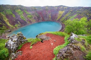 Volcano crater with a turquoise lake inside, Iceland landscape.