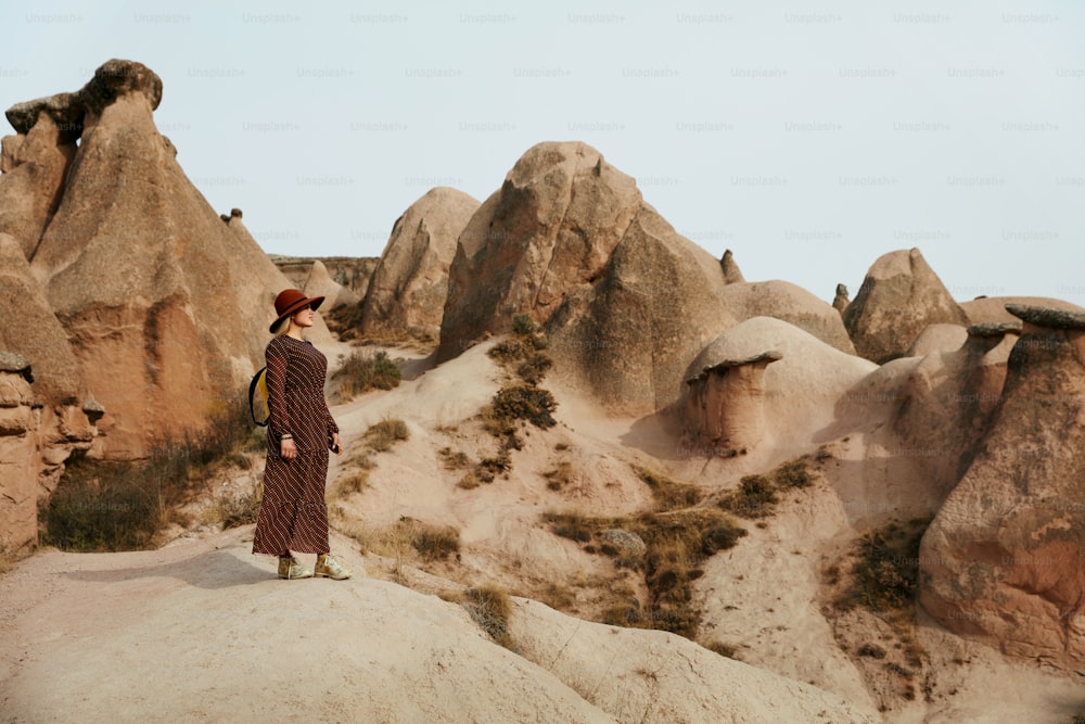Woman Traveling, Exploring Nature Of Rocks Valley. Female Traveler Travel At Desert Canyon. High Resolution