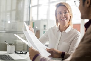 Businesswoman suggesting her partner to sign a contract