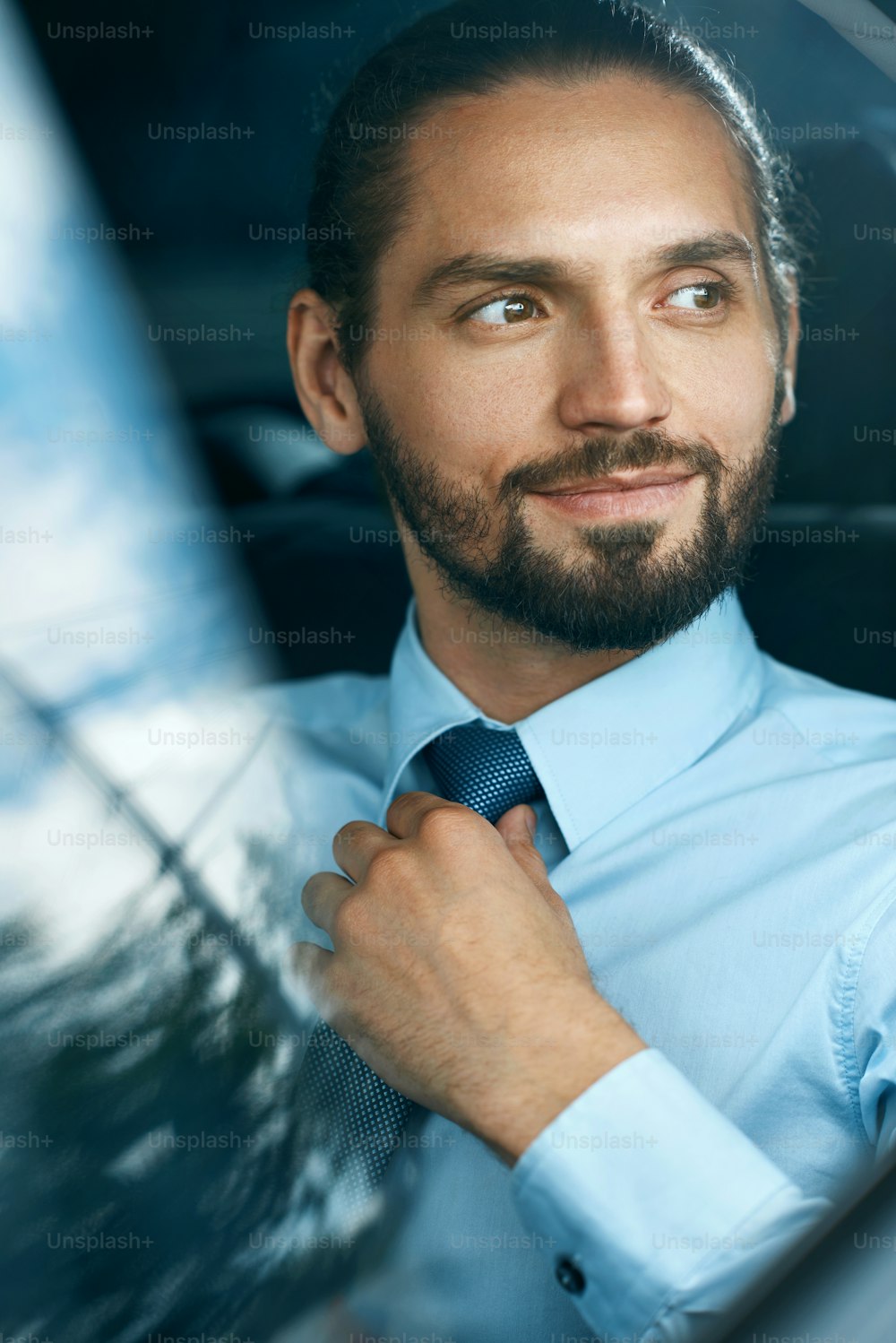 Business Man Going To Work In Car. Portrait Of Handsome Successful Young Businessman In Formal Wear Traveling On Back Seat Of Vehicle And Looking Through Window. Business Travel. High Quality Image.