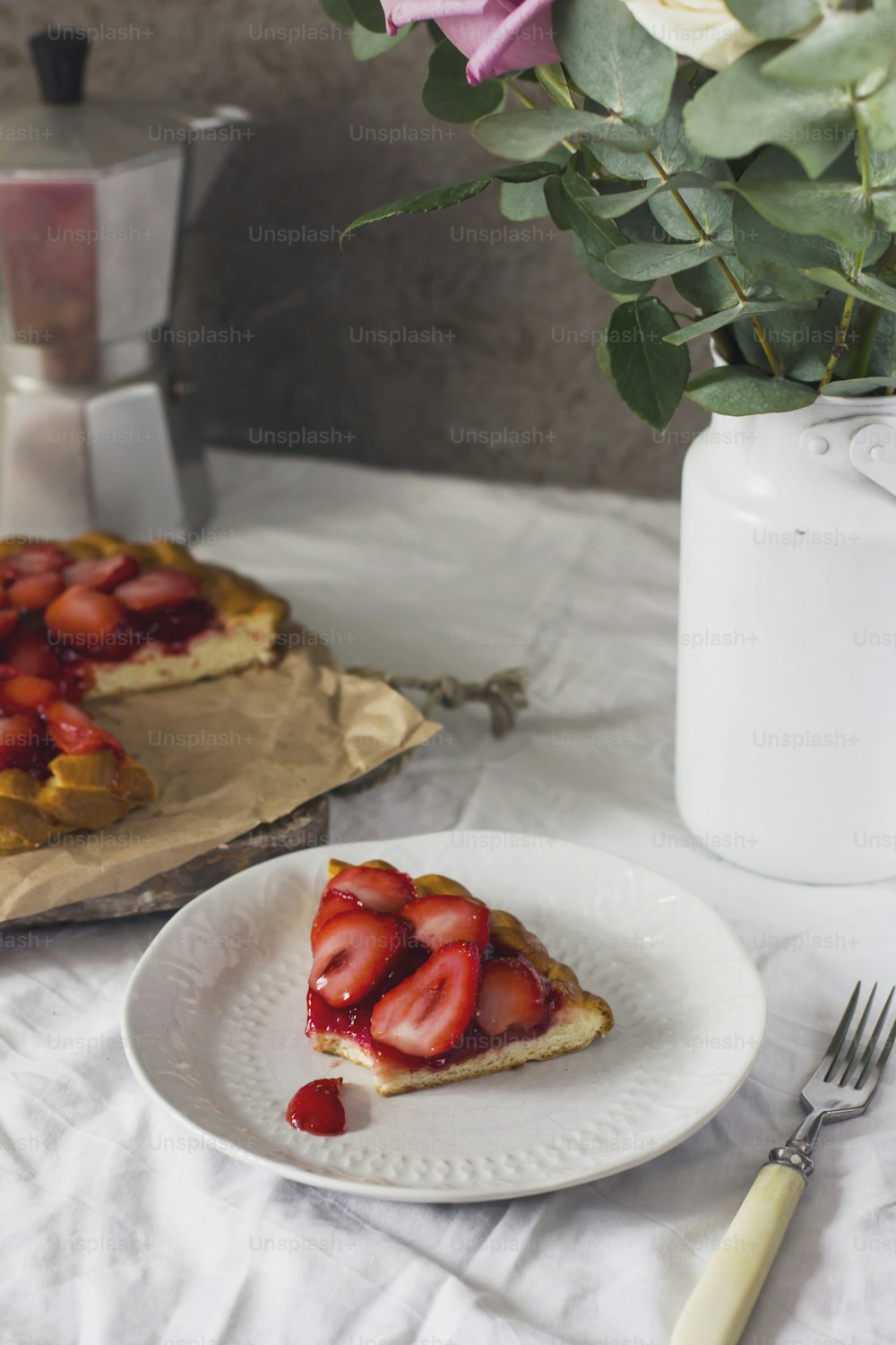 Dining table with flowers, coffee maker and strawberry pie, rustic style