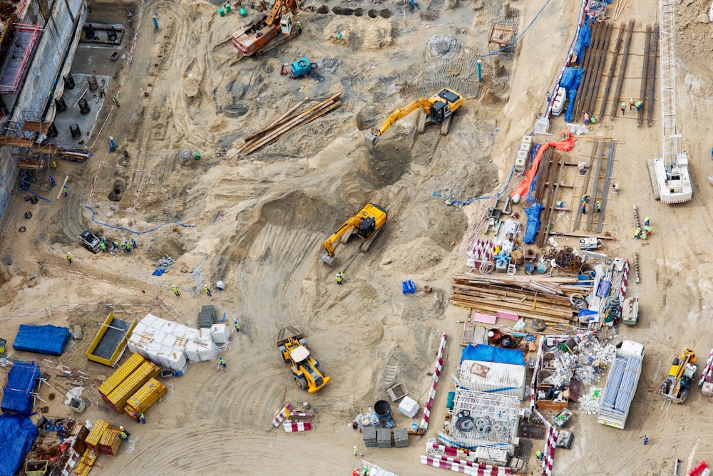 Top view of construction sites and a lot of machines and workers in Dubai, UAE.