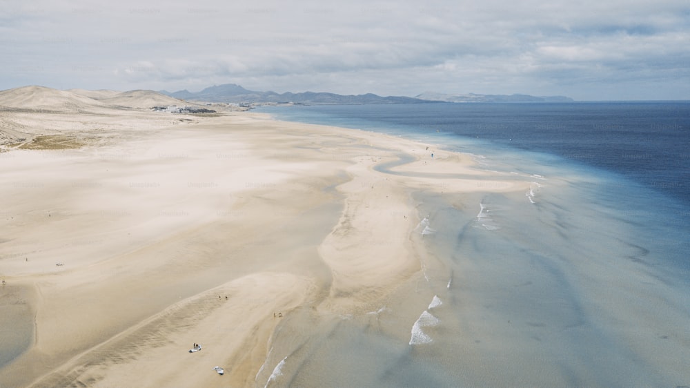 Amazing tropical beach anc blue transparent sea ocean water. Aerial view of coastline and amazing seascape landscape with horizon and sky and mountains in background. Summer travel