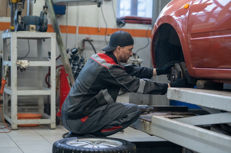 Mechanic performing precision wheel alignment service at Madison Avenue Tires in Paterson NJ