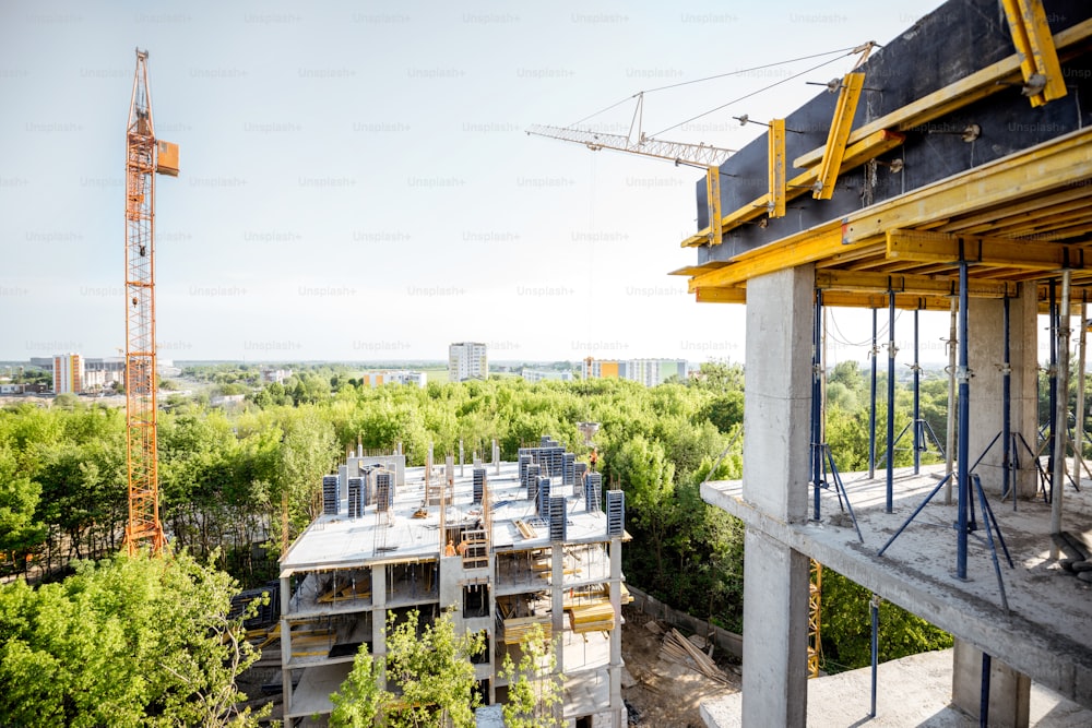 View on the residential building during the construction process in the green forest