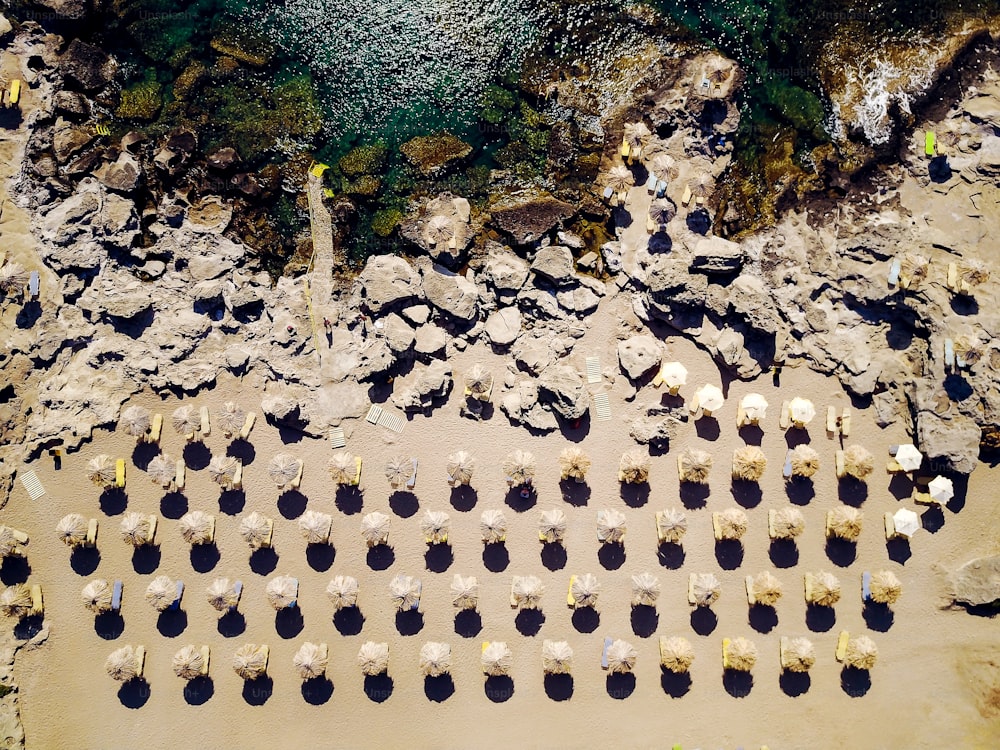 Top view of the beach with tourists and umbrellas at summer vacation.