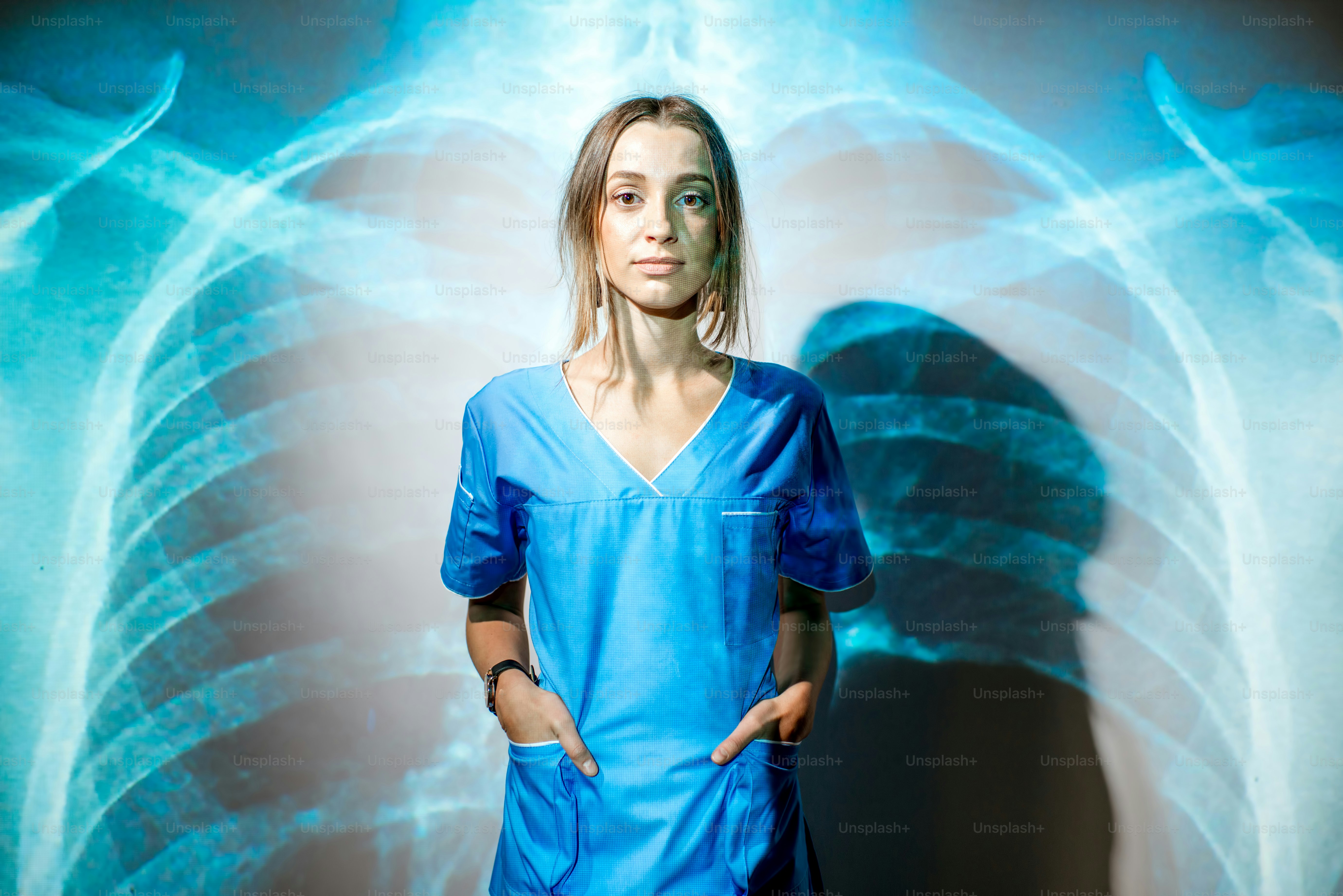 Portrait of a young woman nurse in uniform with projected x-ray of human lungs