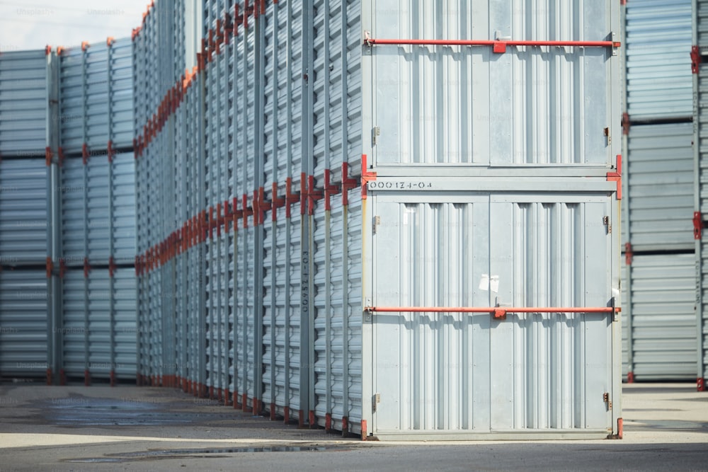 Stack of huge new metallic storage containers with closed doors