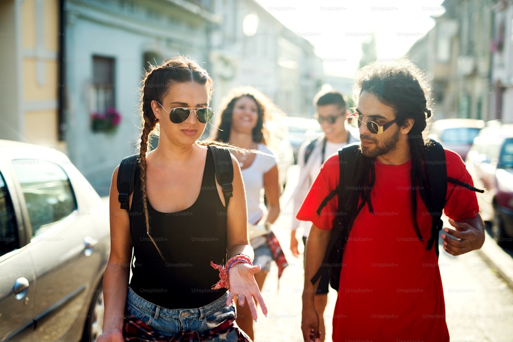 Group of young friends is walking in new town.