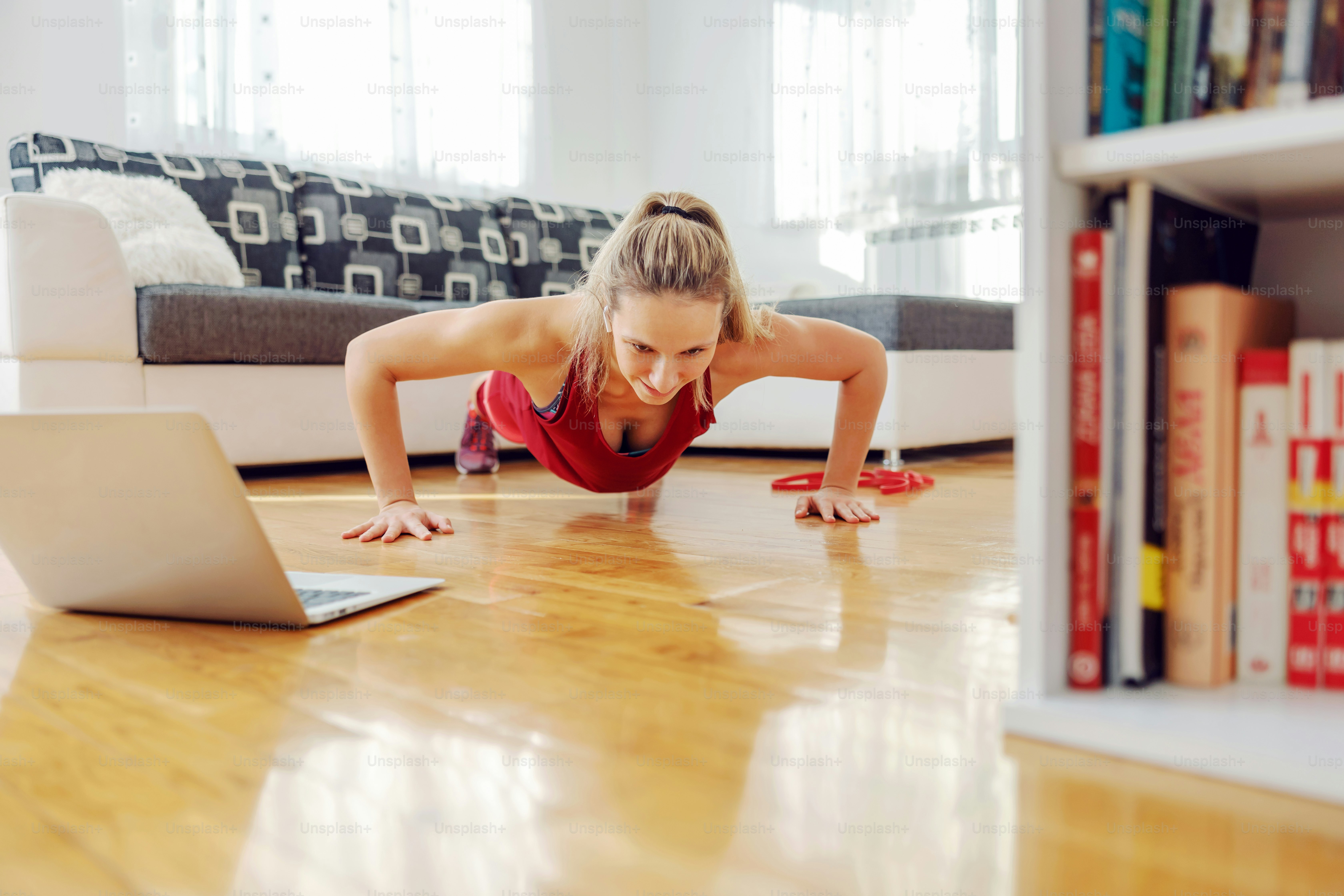 Strong fitness instructor doing pushups and having online class.