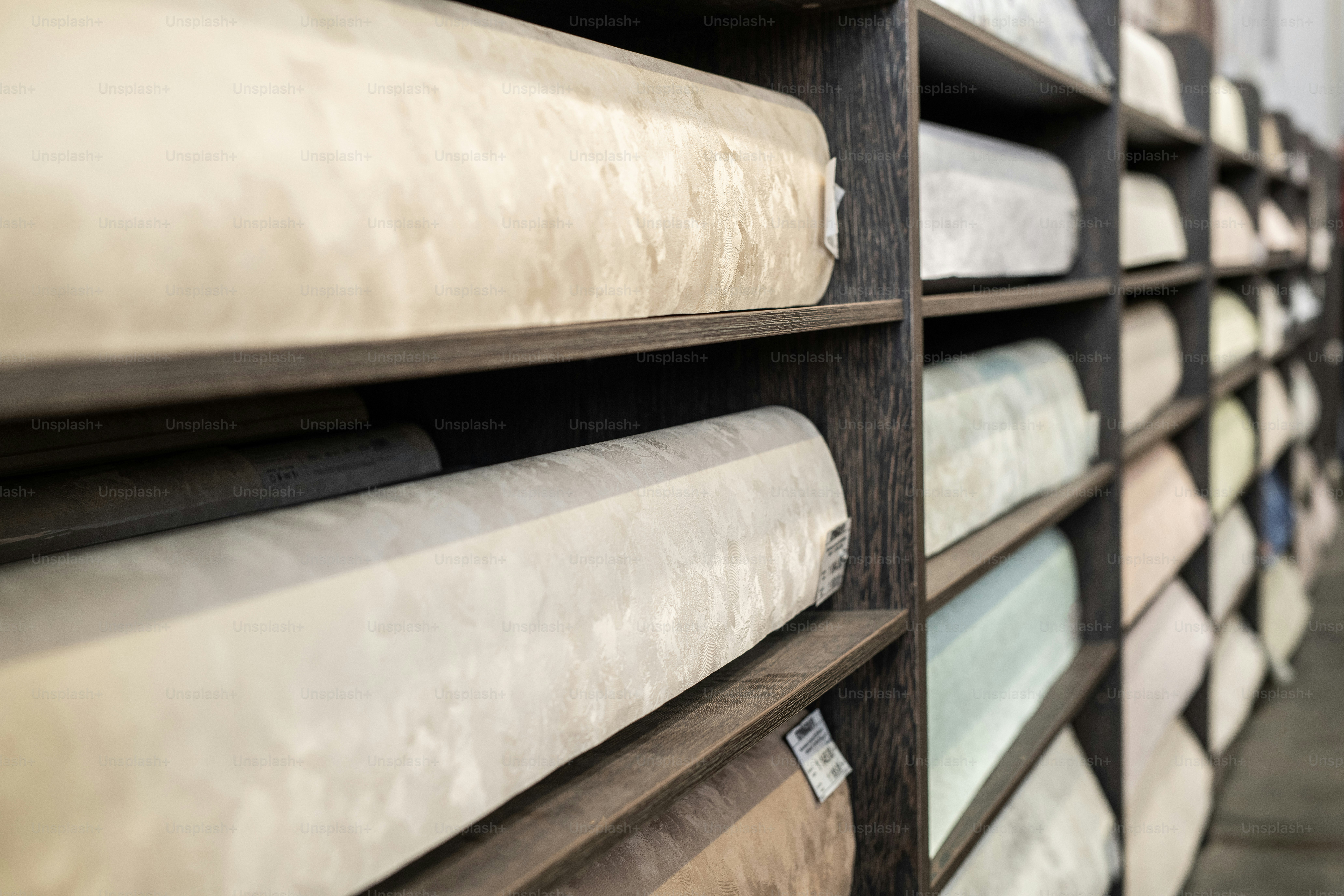 Shelves with rolled wallpapers in large hardware store
