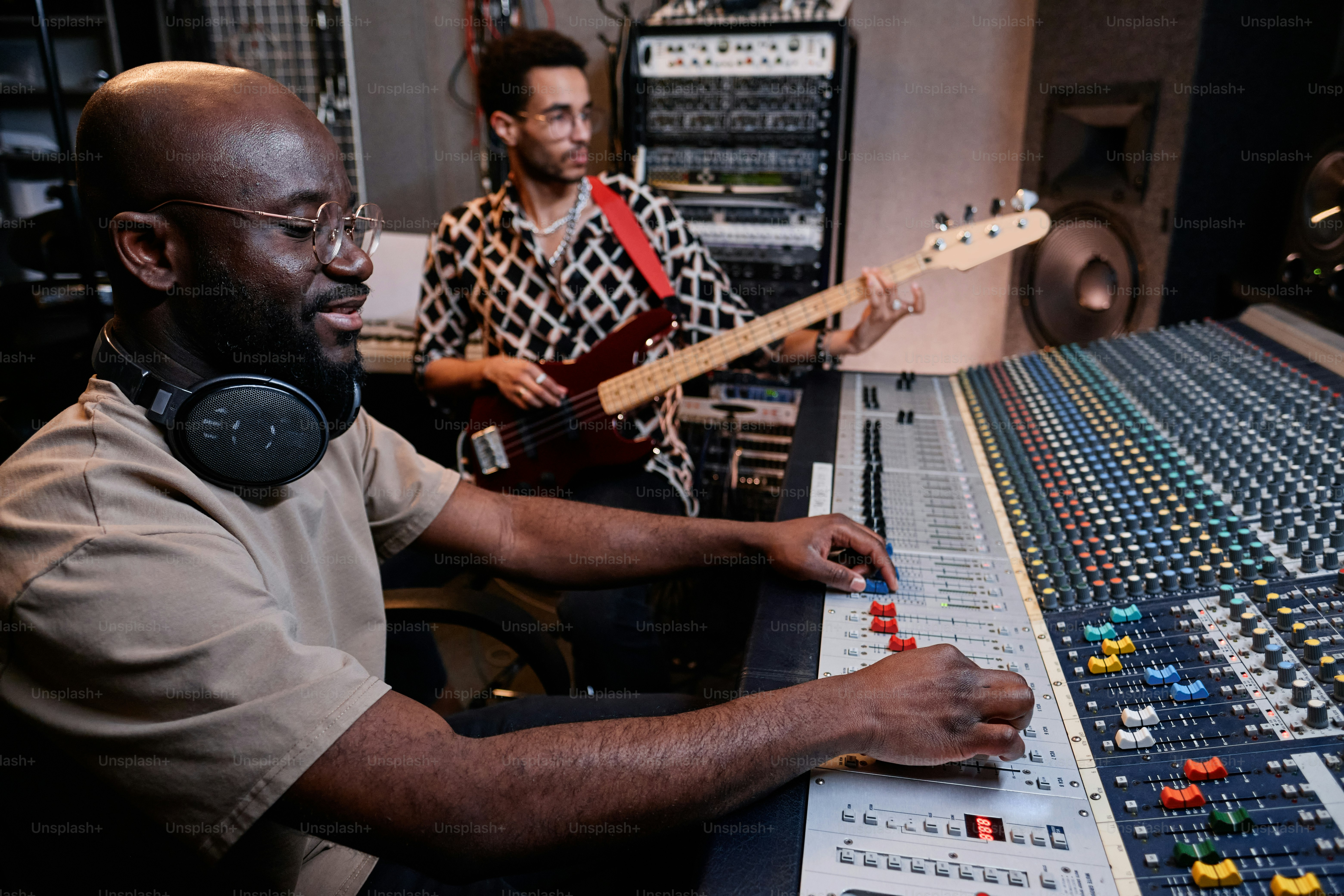 Modern young Black musician playing electric guitar while sound ...