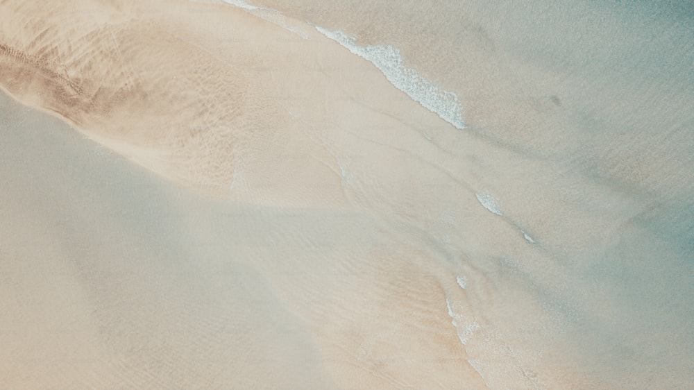 Vertical view of sand and beach with transparent clean sea water. Summer holiday vacation above landscape concept. Travel tropical destination scenic place.