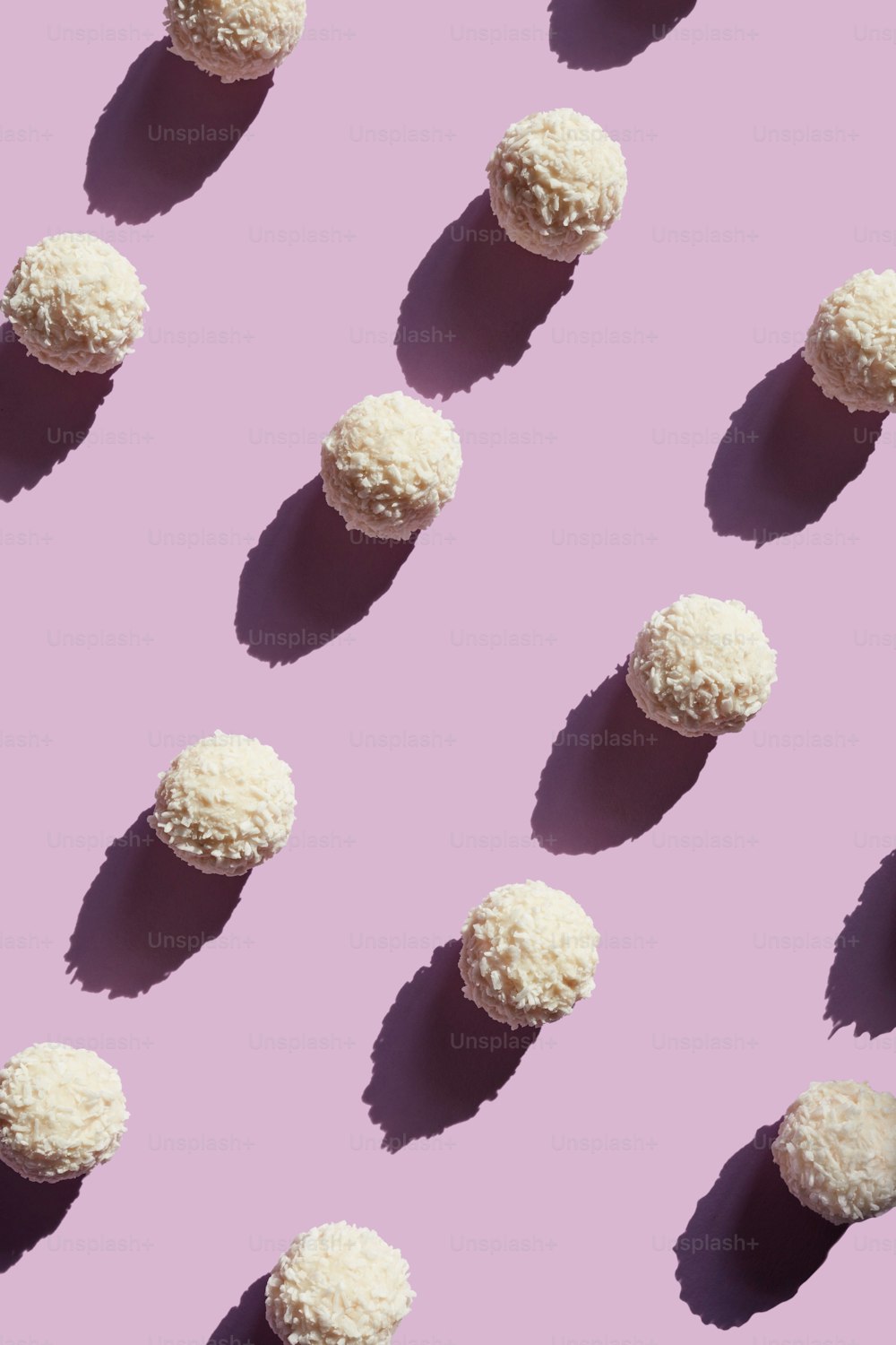 Sweets. Coconut Candy Balls On Purple Background. High Resolution