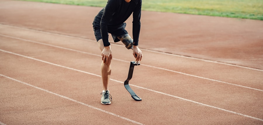 Runner with prosthetic leg on athletics track