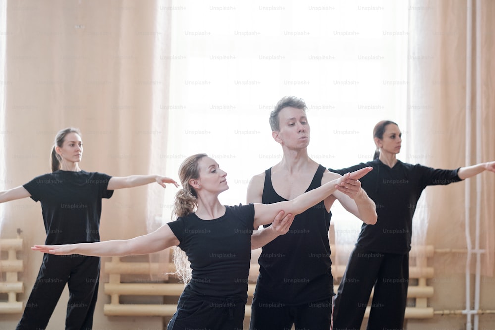 Horizontal shot of three young women having rehearsal in their contemporary dance school