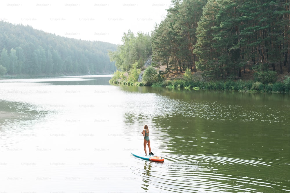 Young woman on sup board