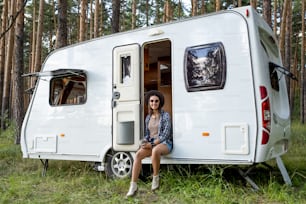 Happy young tripper in casualwear having tea and enjoying summer day