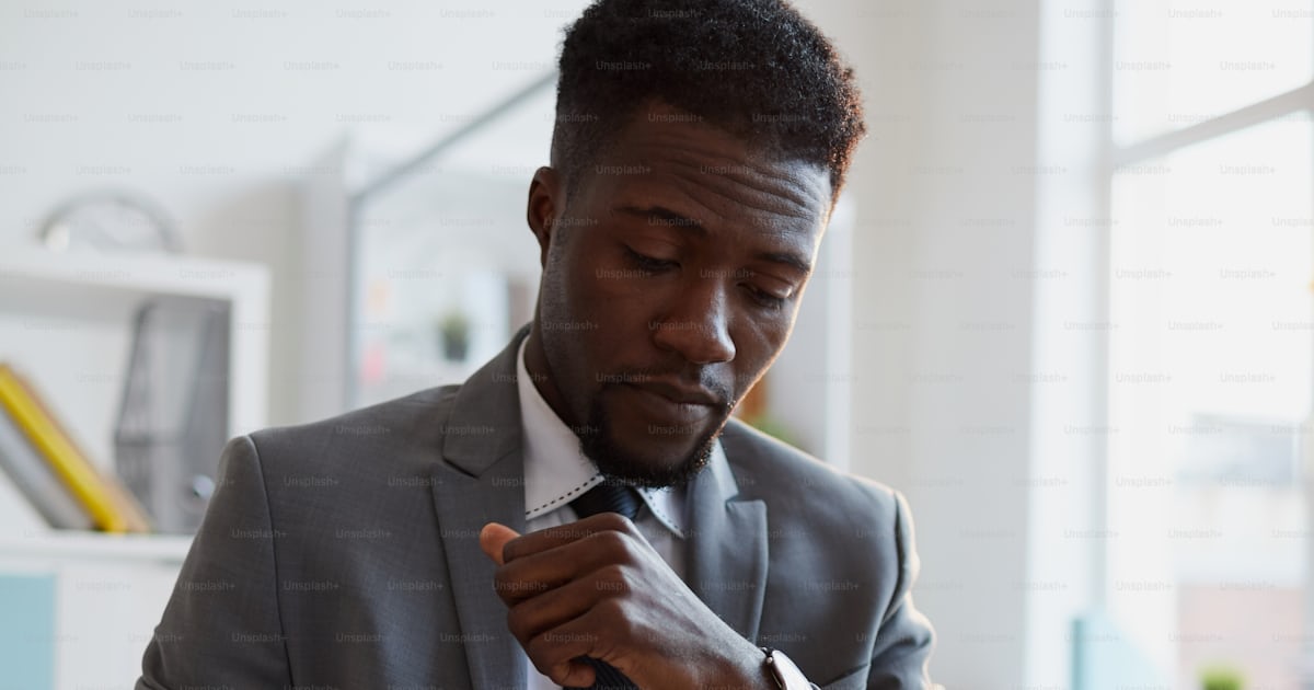 Serious agent or financier with pen reading attentively terms of ...