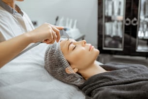 Woman during a vacuum hydro peeling at the luxury beauty salon, close-up view Concept of a professional facial treatment
