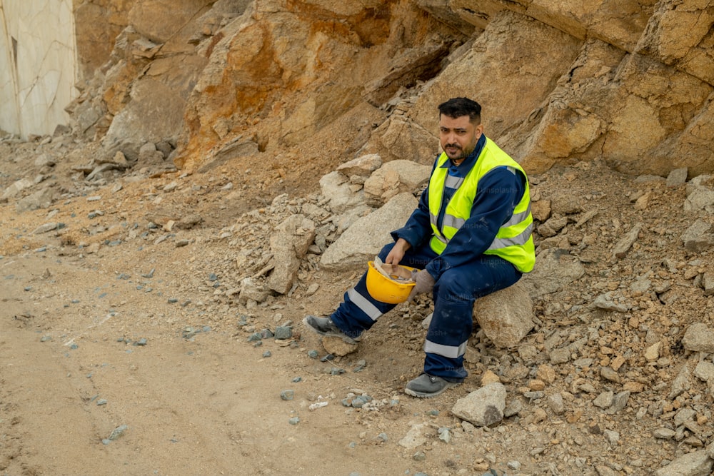 Restful builder in uniform having break at construction site