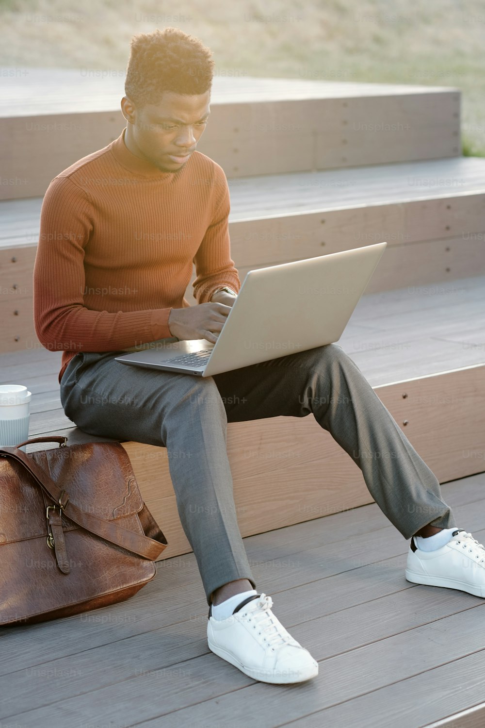 야외에서 노트북 네트워킹을 하는 현대 아프리카 사업가 또는 학생
