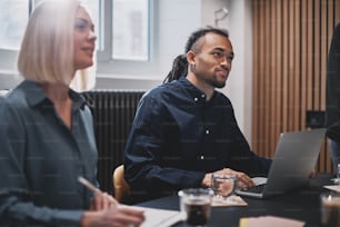 Diverse work colleagues having a meeting together around a table in an office boardroom