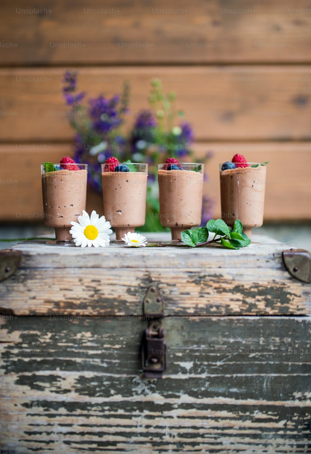 Selection of colorful and delicious cake desserts on a rusty wooden box.