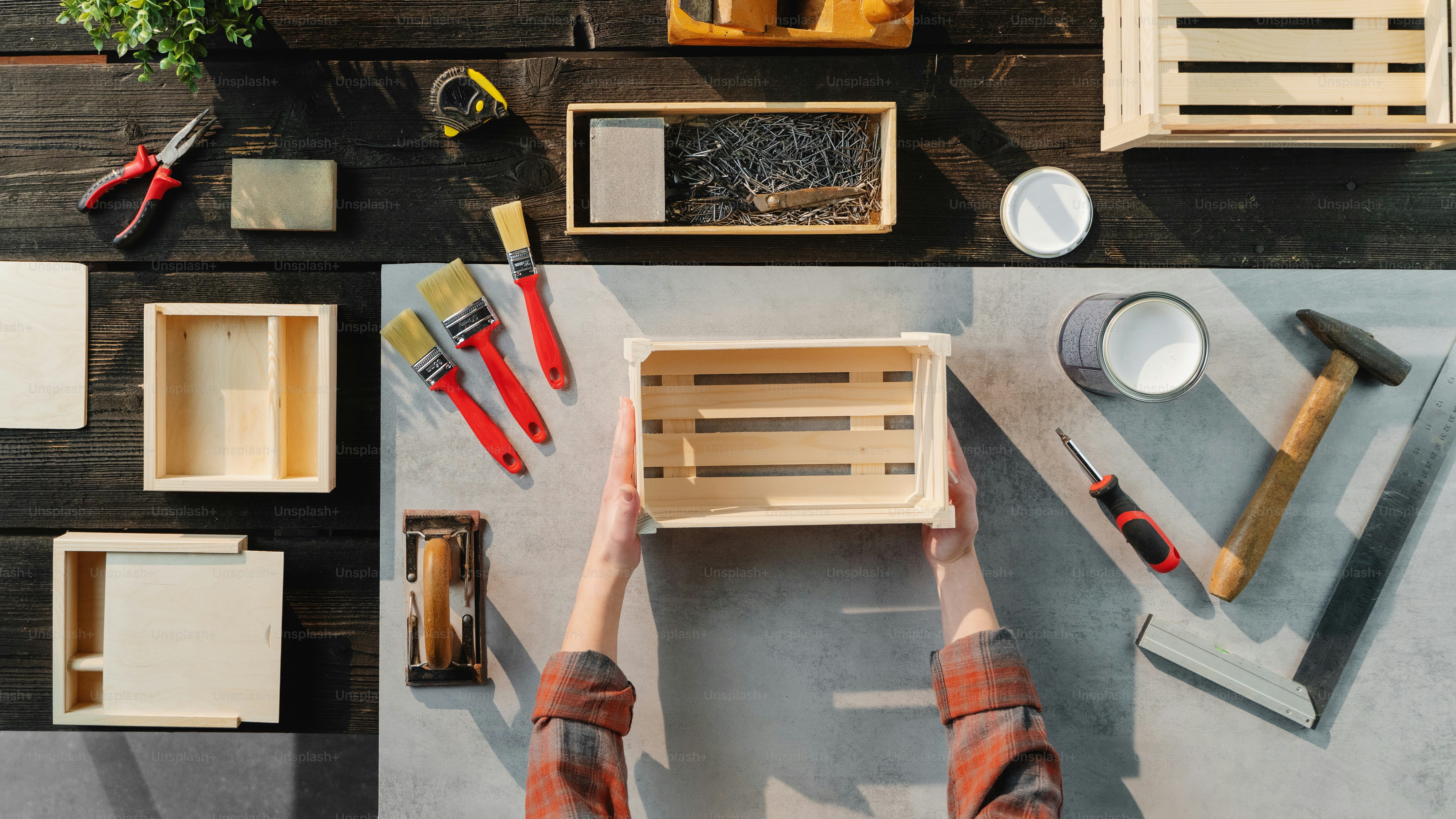A top view of unrecognizable woman making wooden boxes, small business ...