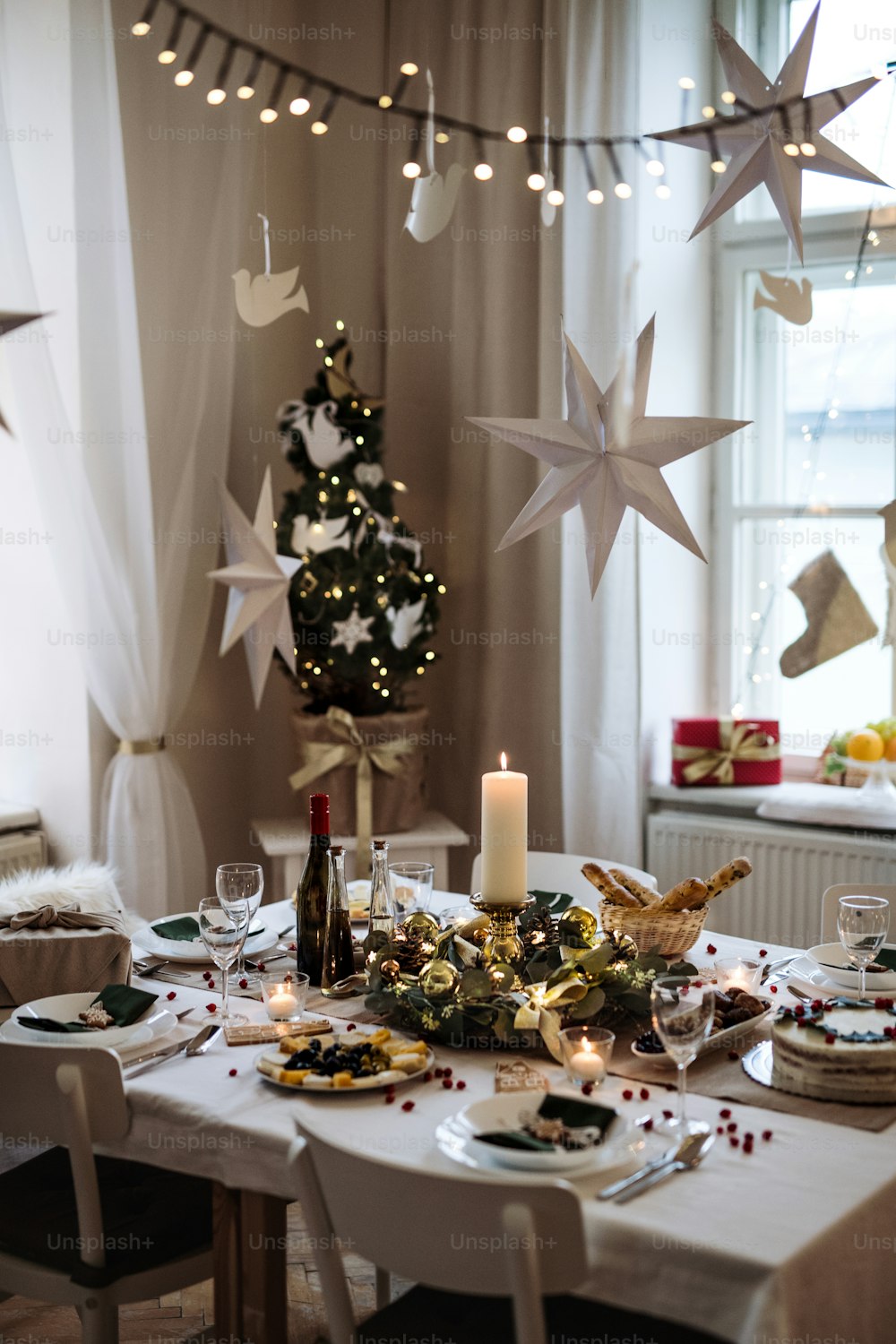 A decorated table set for dinner meal at Christmas time.