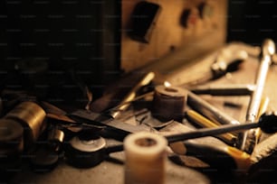 A close up of industrial tools indoors in metal workshop at night.