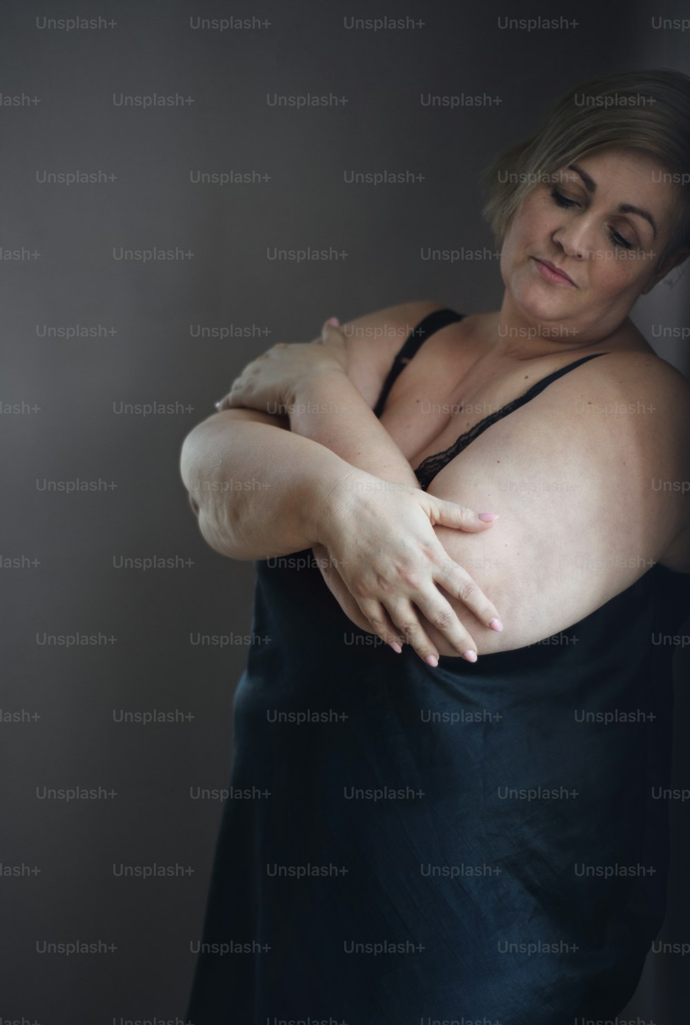 A depressed lonely fat woman in underwear at home.