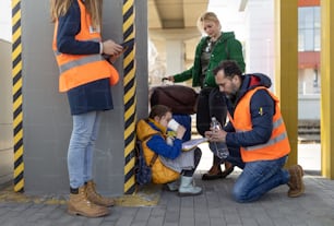 Volunteers helping an Ukrainian refugee family at train station.