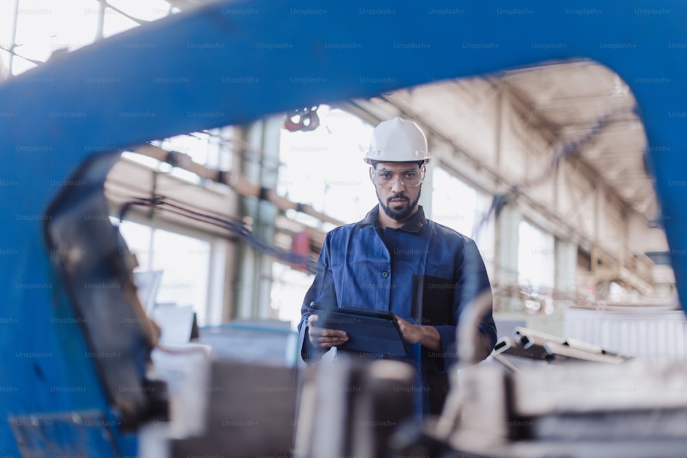 An engineering manager and mechanic worker doing routine check up in industrial factory