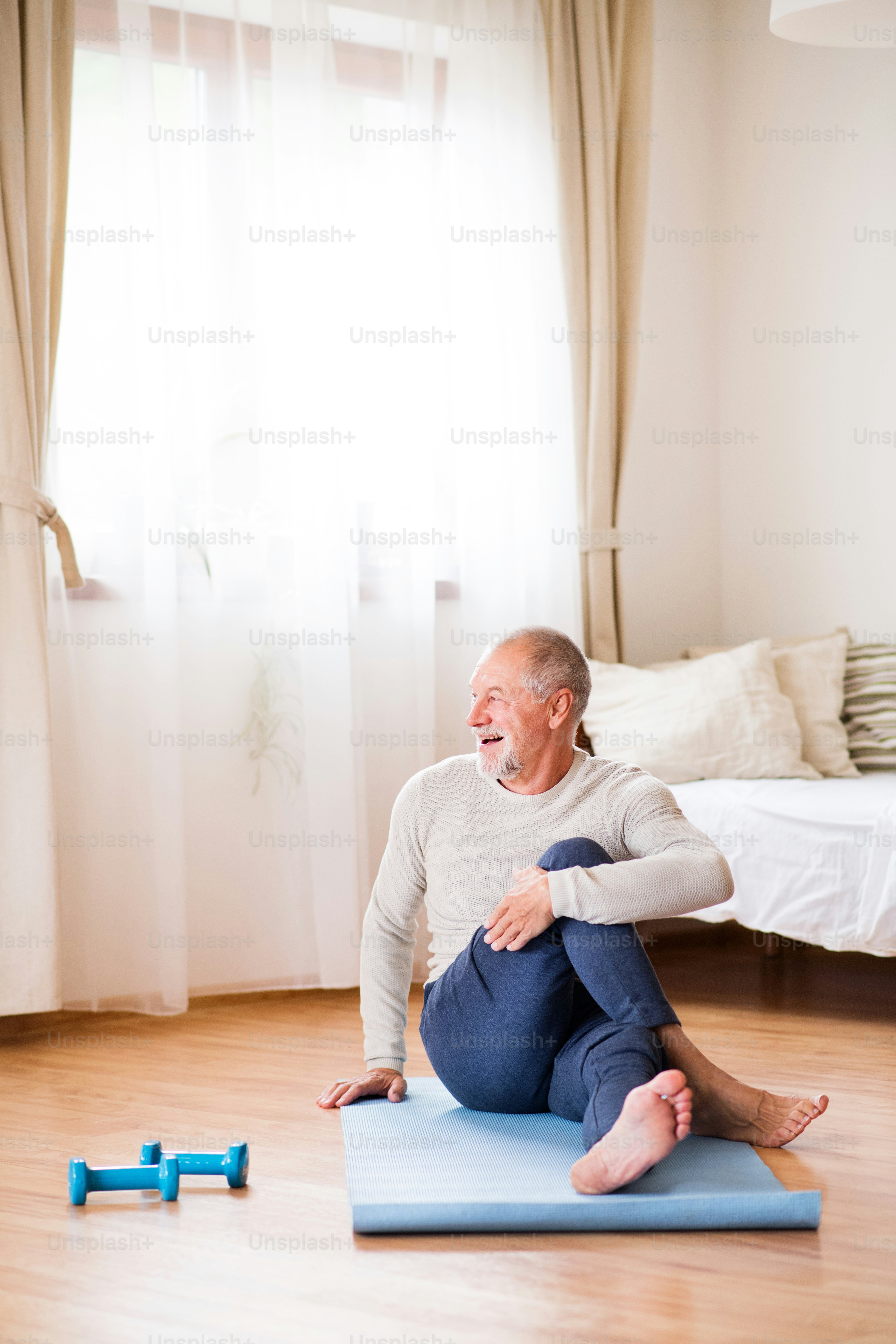 Active senior man doing exercise at home. Man next to a wheelchair ...