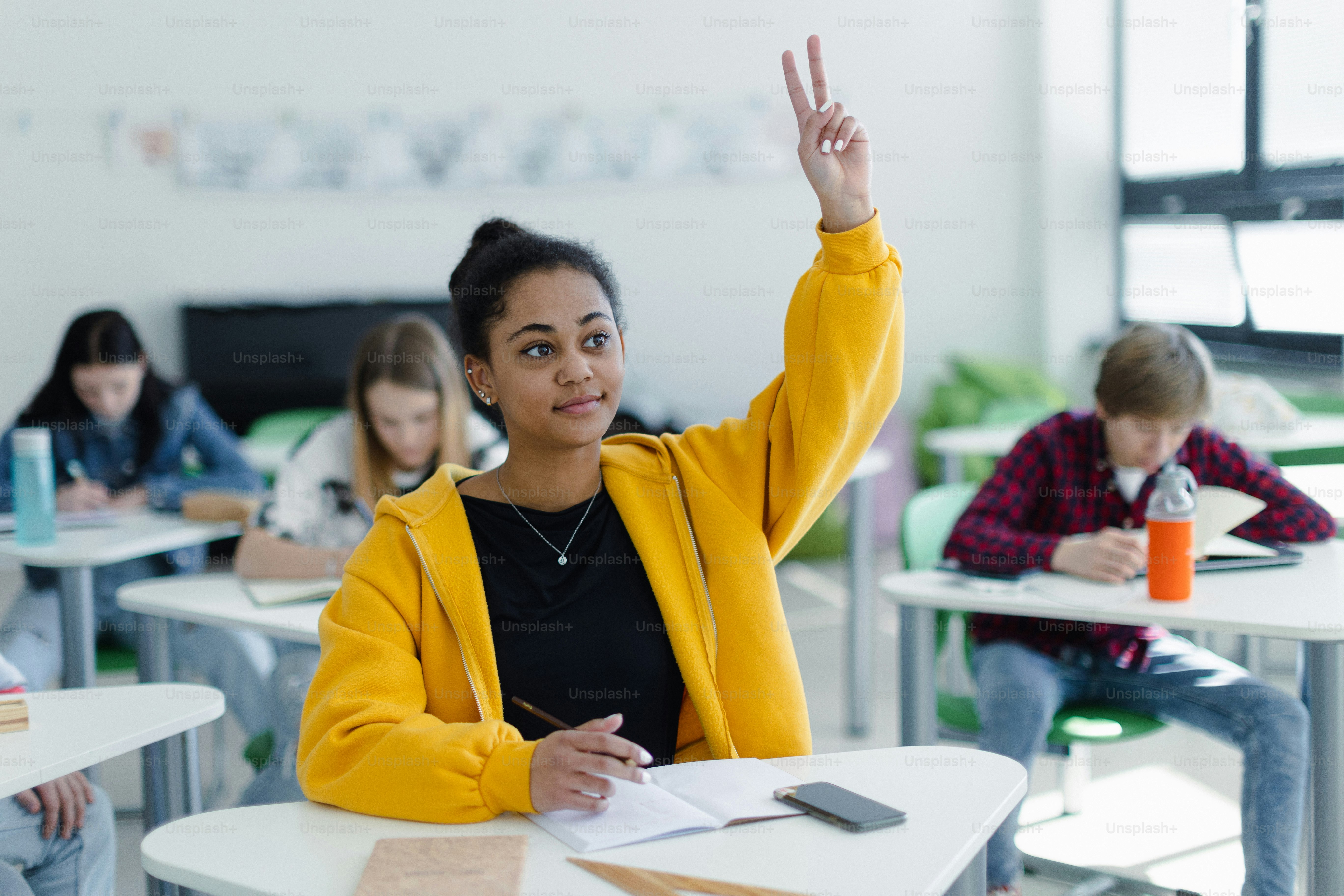 High School Students Paying Attention In Class, Sitting In Their Desks ...